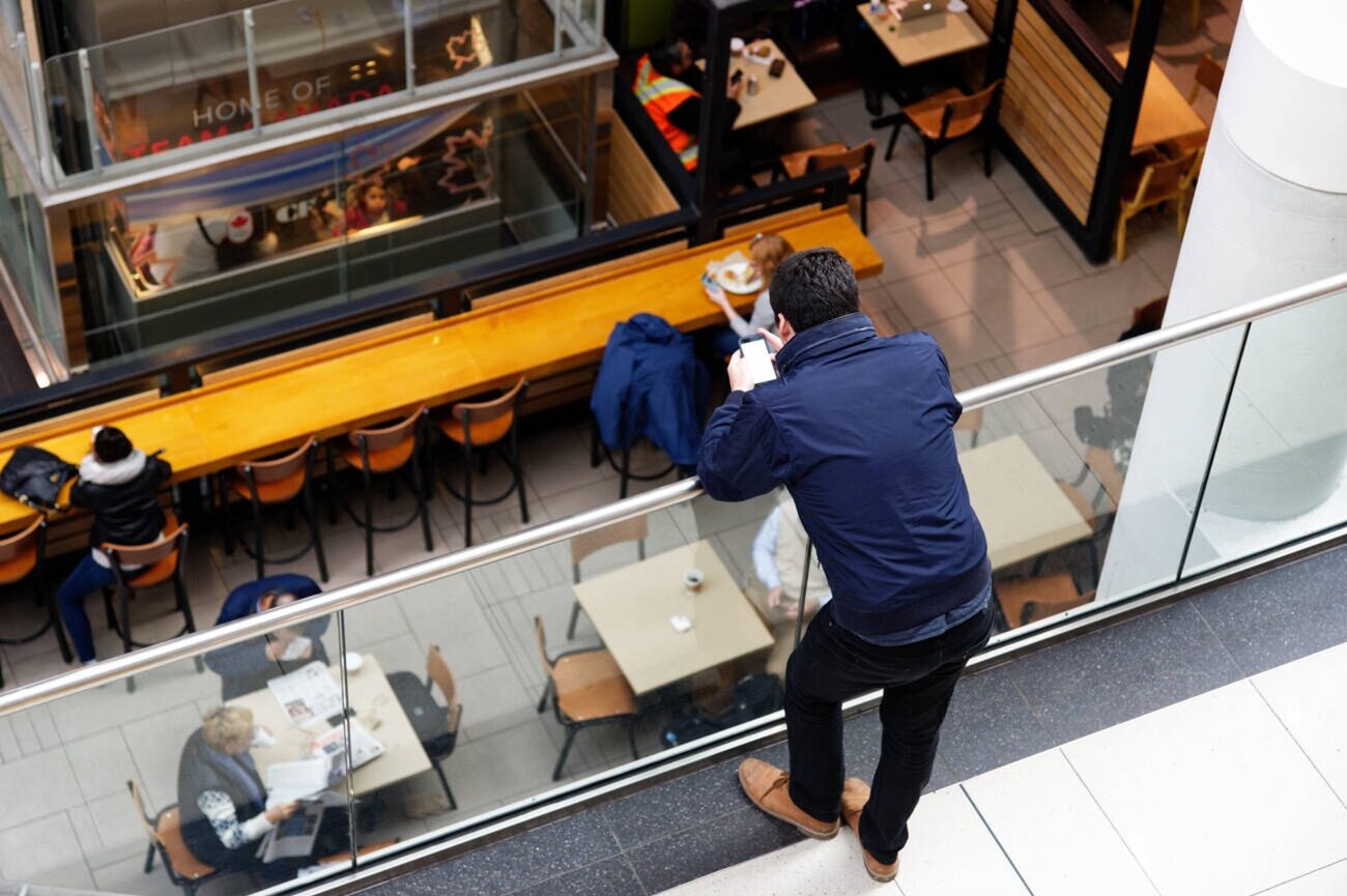 man using phone inside mall | WaveBoosters UK